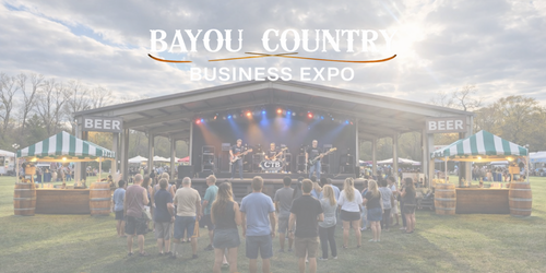 Outdoor event with stage and attendees at Bayou Country Business Expo
